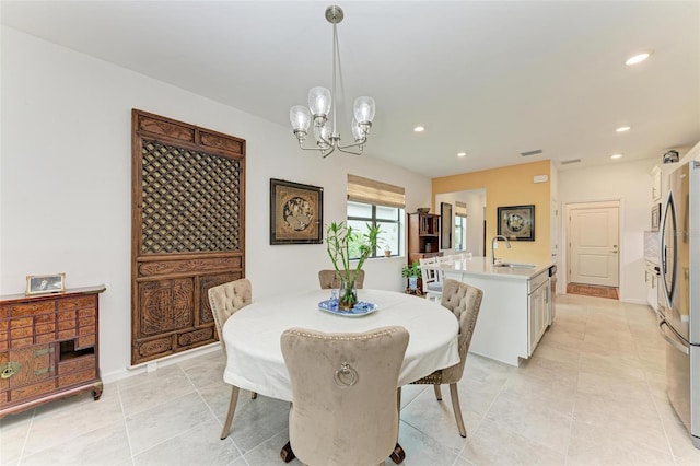 dining room featuring light tile patterned flooring, sink, and an inviting chandelier