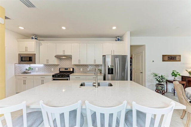 kitchen featuring sink, stainless steel appliances, and white cabinetry