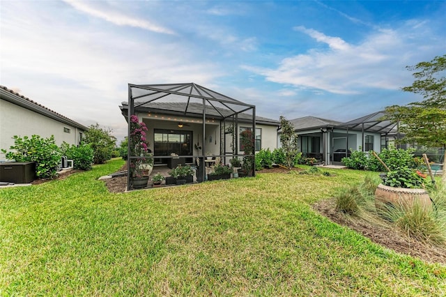 back of property with a lanai and a yard