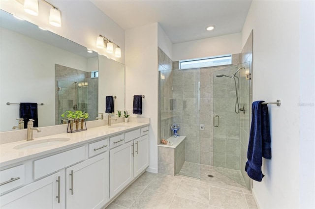 bathroom featuring tile patterned floors, an enclosed shower, and vanity