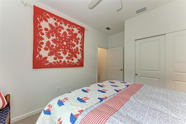 carpeted bedroom with ceiling fan and a closet