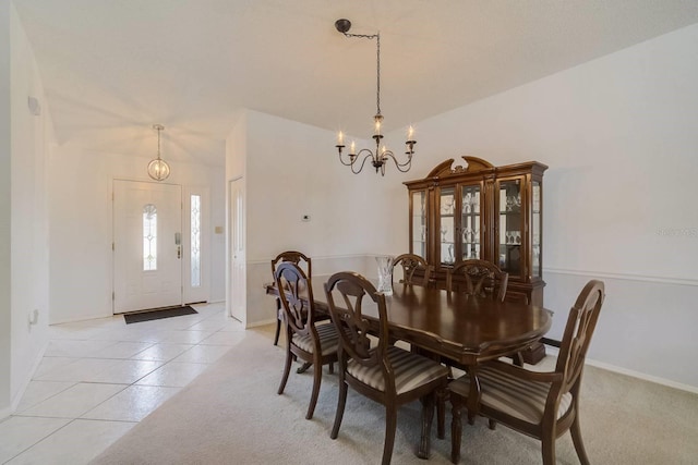 dining area with a chandelier and light tile patterned flooring