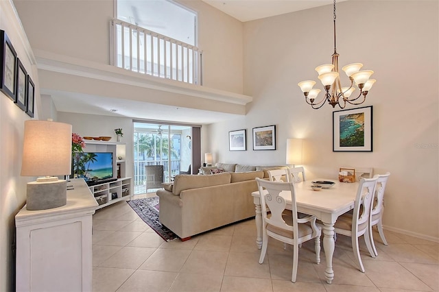 tiled dining space with a chandelier and a high ceiling