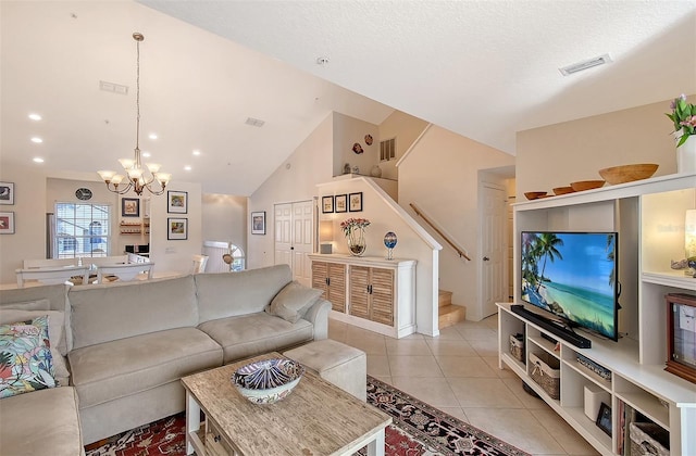 living room with high vaulted ceiling, a chandelier, and light tile patterned floors