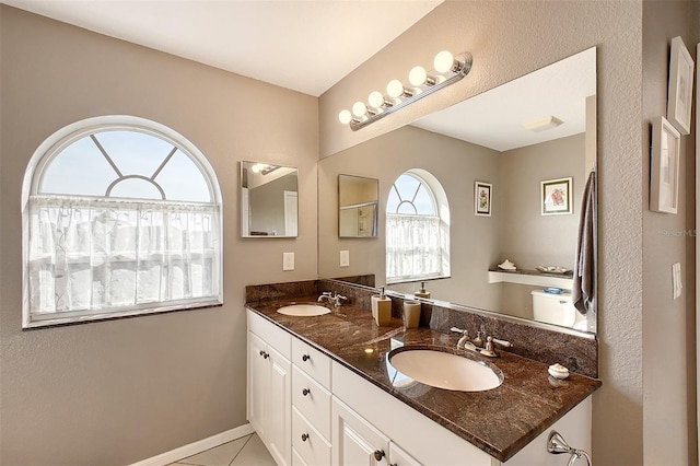 bathroom with tile patterned floors and vanity