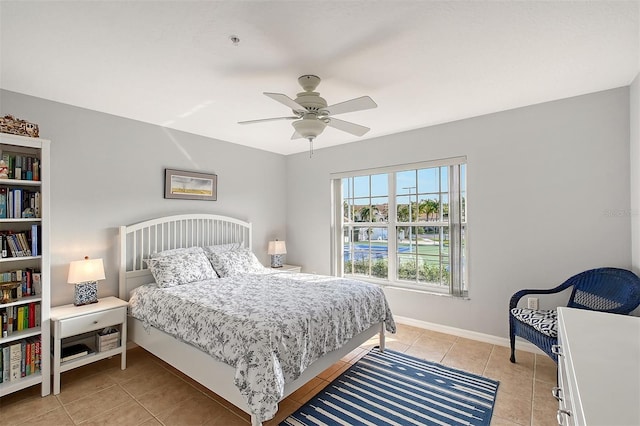 bedroom with ceiling fan and light tile patterned floors