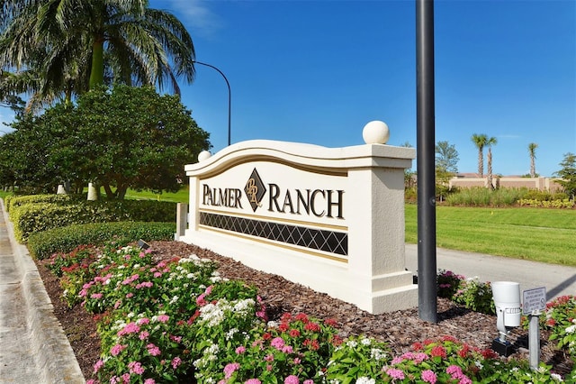 community / neighborhood sign with a yard