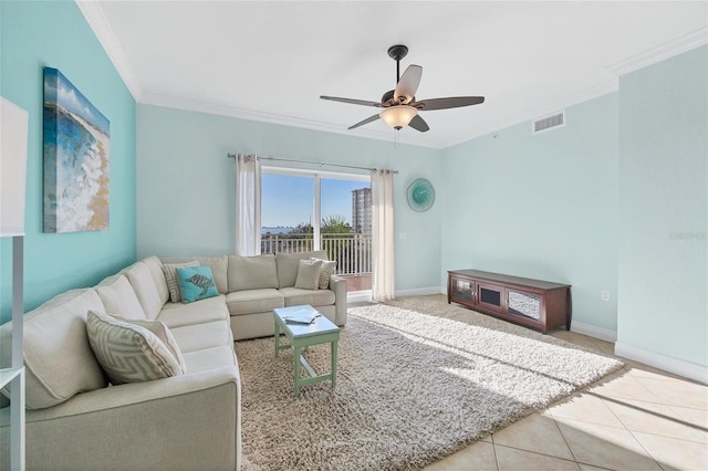 living room featuring ceiling fan, tile patterned flooring, and crown molding