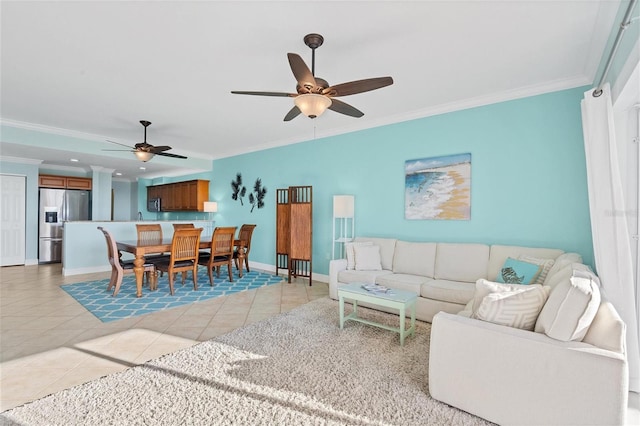 tiled living room with ceiling fan and crown molding