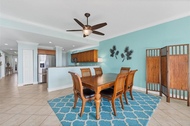 tiled dining area with ceiling fan and ornamental molding