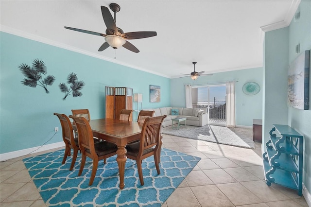 dining space with light tile patterned floors, ornamental molding, and ceiling fan