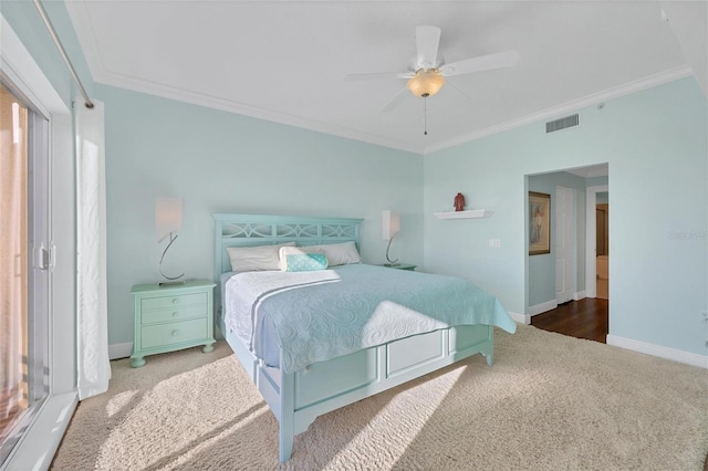 carpeted bedroom featuring ceiling fan and ornamental molding