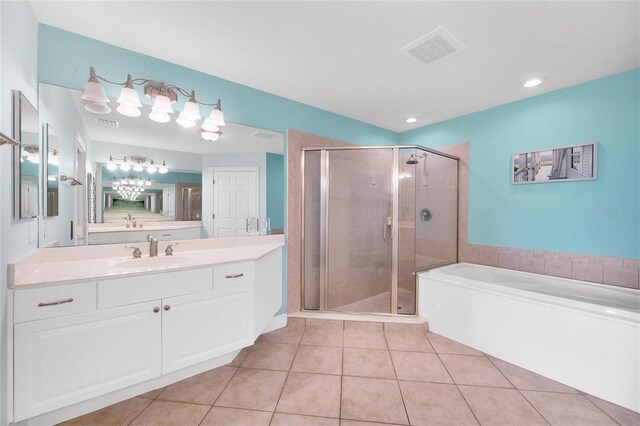 bathroom featuring shower with separate bathtub, vanity, and tile patterned flooring