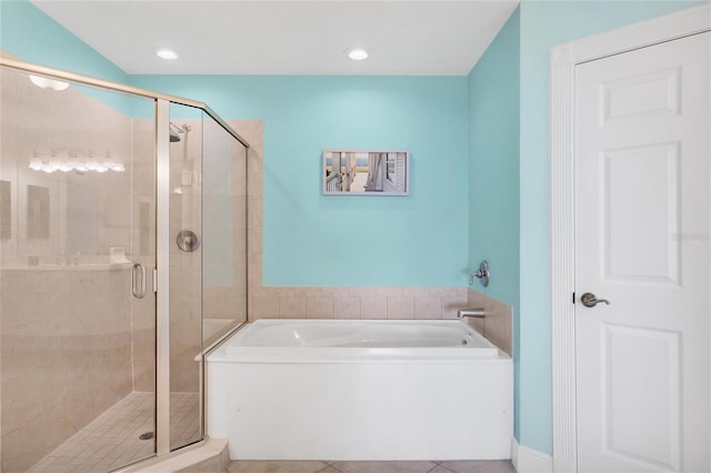 bathroom featuring tile patterned floors and shower with separate bathtub