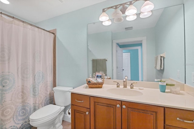 bathroom with toilet and vanity