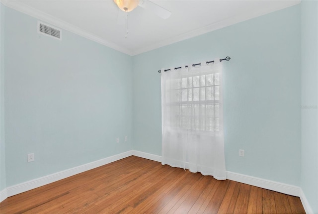 spare room featuring hardwood / wood-style flooring, crown molding, and ceiling fan