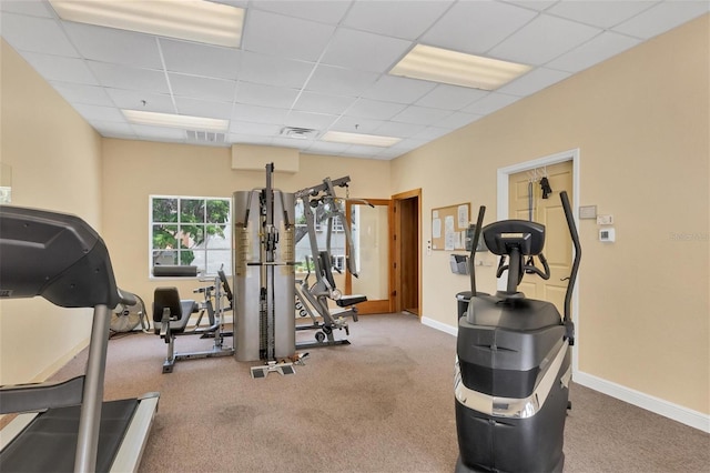 exercise room with carpet and a drop ceiling