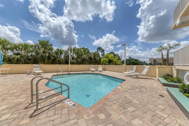 view of swimming pool with a patio