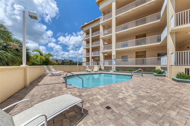 view of swimming pool with a patio