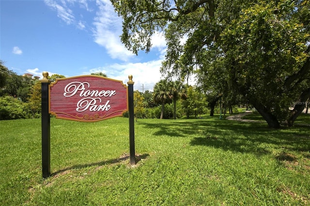 community sign featuring a lawn