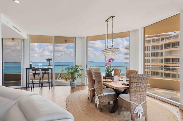 3060 Grand Bay Blvd Unit 175, Longboat Key, FL 34228 - dining room featuring wood finished floors, floor to ceiling windows, and a chandelier