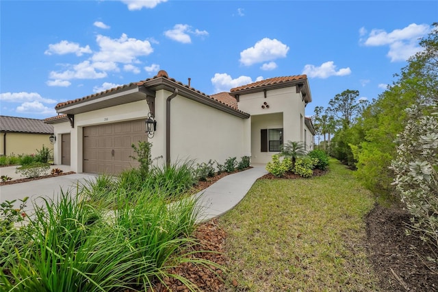 mediterranean / spanish house featuring a garage and a front lawn