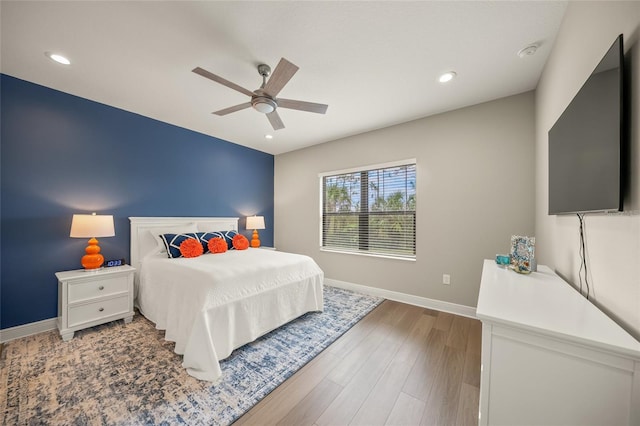 bedroom with ceiling fan and hardwood / wood-style flooring