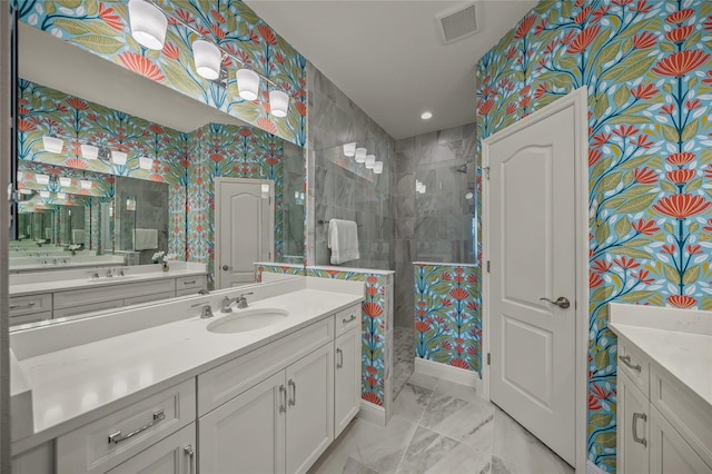 bathroom featuring vanity and tiled shower