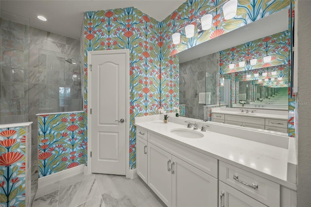 bathroom featuring tiled shower and vanity