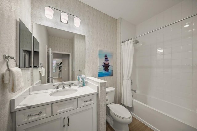 full bathroom featuring toilet, shower / bathtub combination with curtain, hardwood / wood-style flooring, and vanity