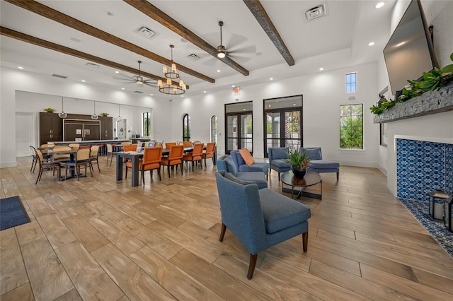 living room featuring ceiling fan and beamed ceiling