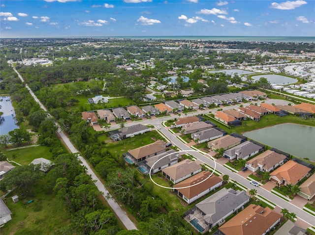 birds eye view of property with a water view