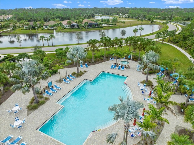 view of pool featuring a water view and a patio