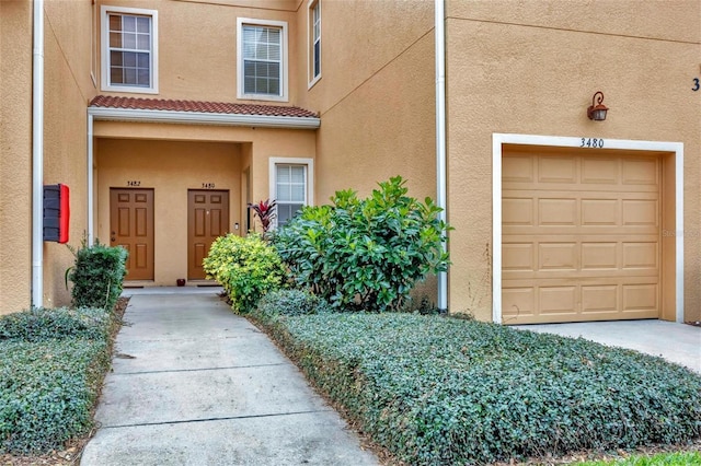 view of exterior entry with a garage