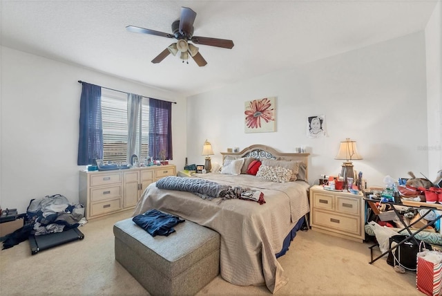 bedroom with ceiling fan and light colored carpet