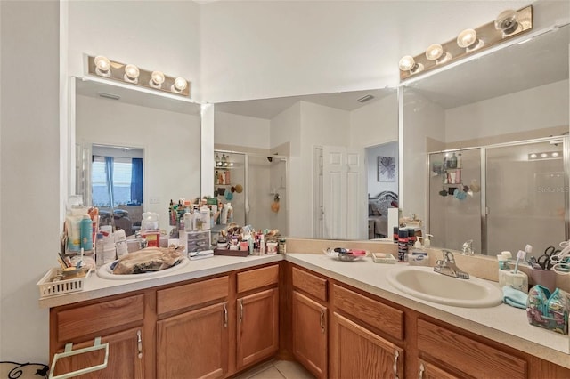 bathroom featuring vanity, tile patterned floors, and a shower with door