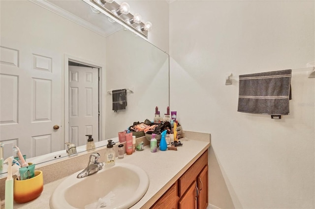 bathroom with vanity and ornamental molding