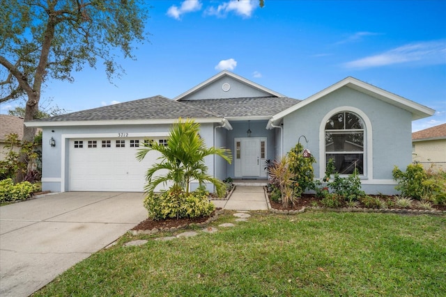 ranch-style house with a garage and a front lawn