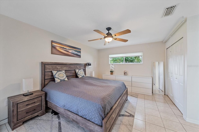 tiled bedroom with a closet and ceiling fan