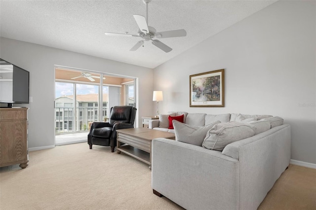 carpeted living room with ceiling fan, a textured ceiling, and lofted ceiling