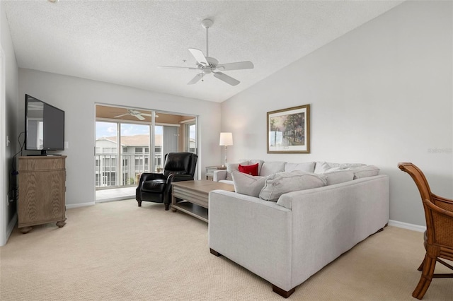 carpeted living room featuring a textured ceiling, ceiling fan, and lofted ceiling