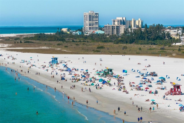 birds eye view of property featuring a view of the beach and a water view