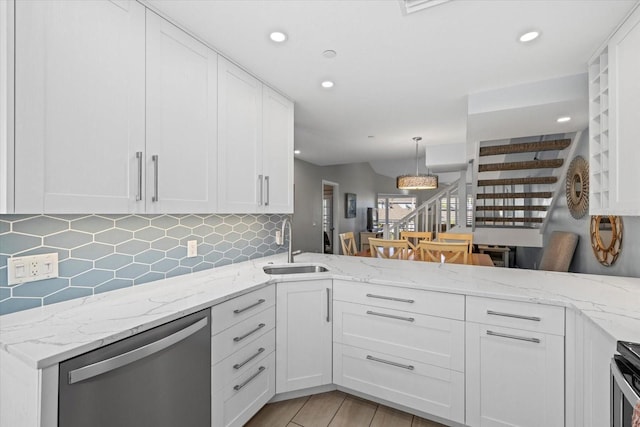 kitchen featuring sink, white cabinetry, dishwasher, and light stone counters