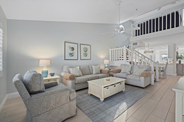 living room featuring ceiling fan and lofted ceiling