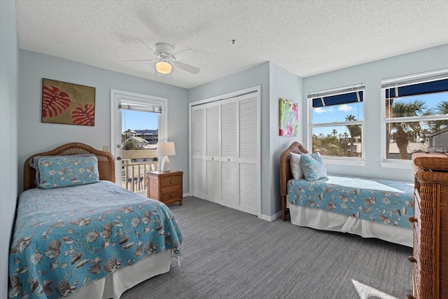 carpeted bedroom with multiple windows, a textured ceiling, a closet, and ceiling fan