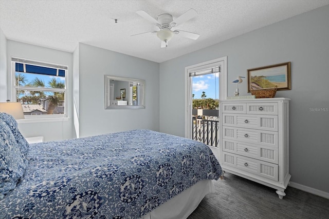 bedroom featuring a textured ceiling, dark colored carpet, access to exterior, and ceiling fan