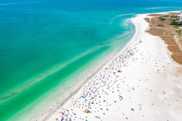 aerial view with a water view and a view of the beach