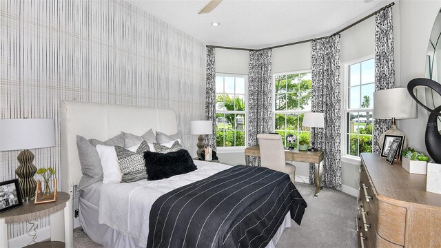 bedroom with light carpet and ceiling fan