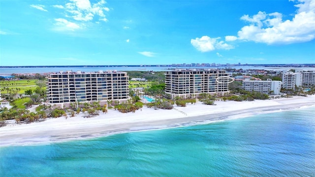 drone / aerial view featuring a water view and a view of the beach