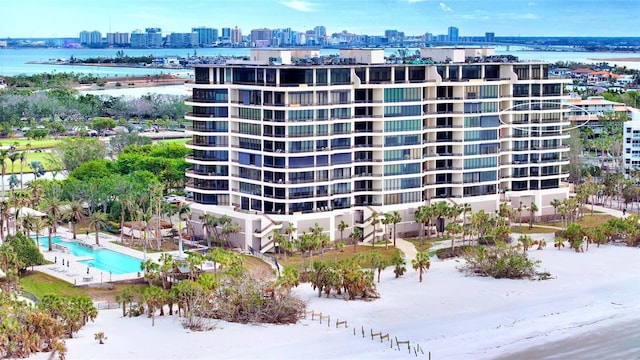 view of building exterior with a view of the beach and a water view